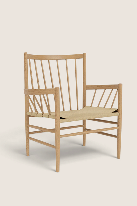 Bolina J82 lounge chair in lacquered oak with a woven paper cord seat and high spindle backrest.