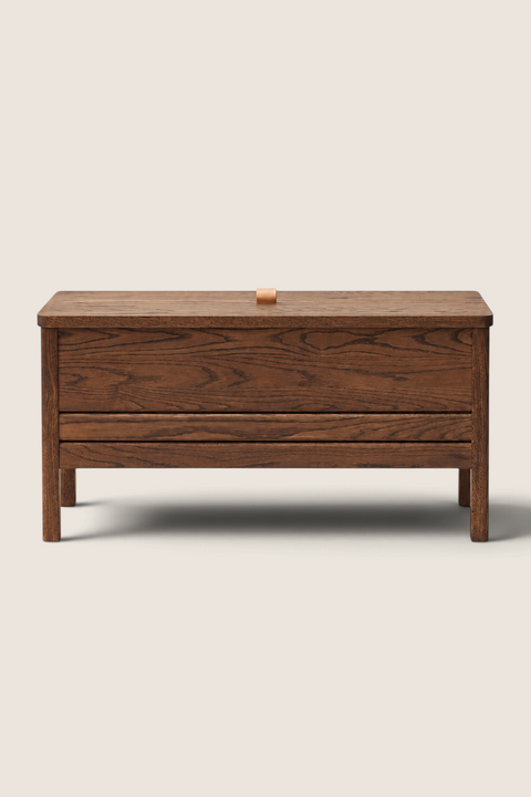 Bolina A Line storage bench in smoked oak with a leather handle, featuring a minimalist design for home storage.
