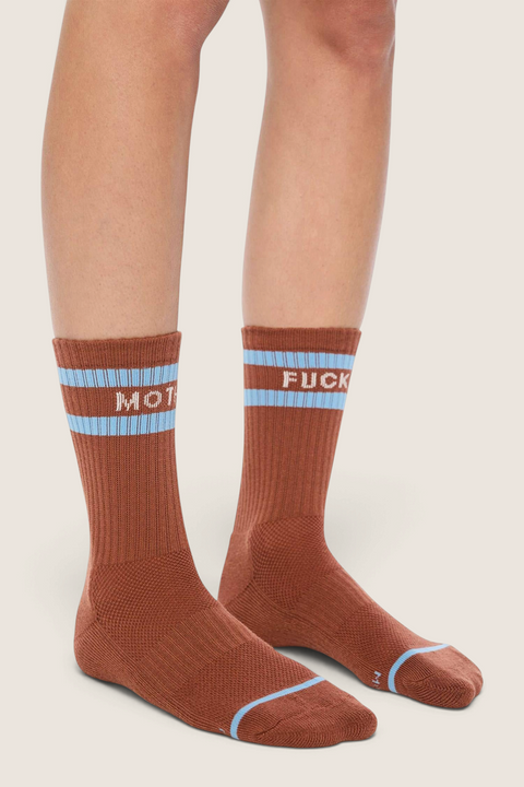 Bolina Baby Steps cocoa brown ribbed tube socks with light blue stripes and white text worn on legs