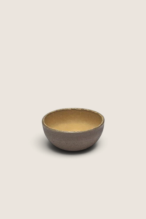 Bolina Serax FCK small bowl with a warm yellow glazed interior and a matte textured exterior finish.