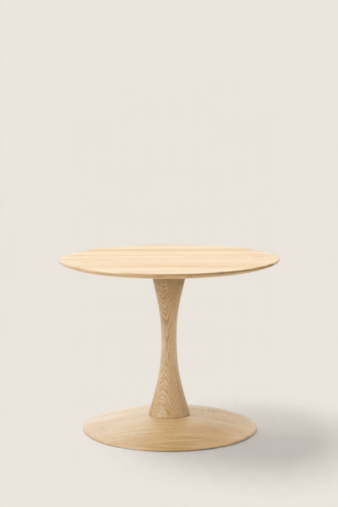 Bolina Trisse coffee table in soap-treated oak with a round top and sculptural pedestal base on a white background.