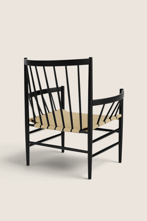 Bolina J82 lounge chair in black beech wood with a natural paper cord woven seat, viewed from the back.
