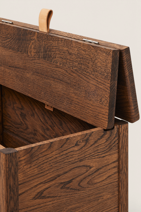 Bolina A Line storage bench in smoked oak with a leather handle and open lid showing interior storage compartments.