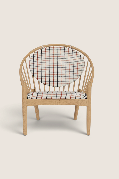 Bolina J166 Jørna lounge chair in lacquered oak with red plaid wool upholstery and iconic spindle back design.