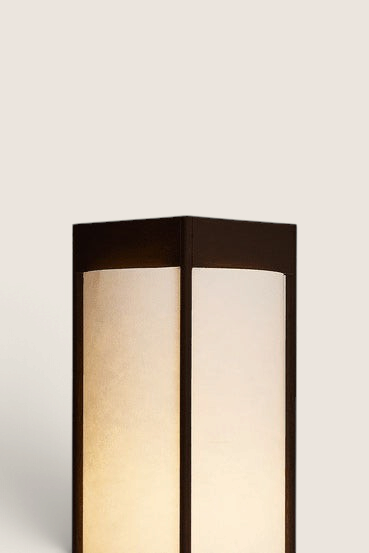 Bolina Andon table lamp in dark brown ash wood with a minimalist, sculptural design and soft glowing light panels.