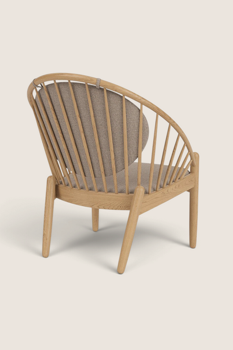 Bolina J166 Jørna lounge chair in lacquered oak with beige upholstery, featuring a curved spindle back design.