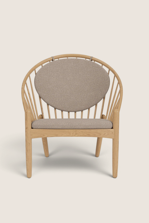 Bolina J166 Jørna lounge chair in lacquered oak with beige fabric cushions and iconic spindle back design