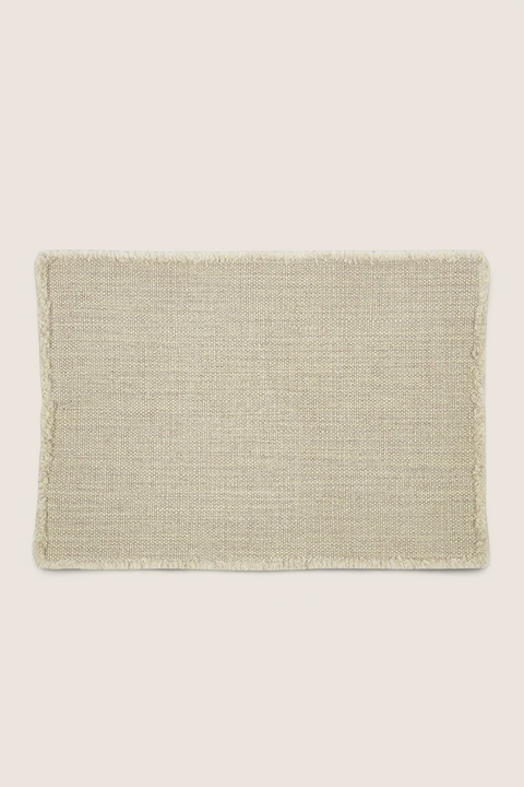 Bolina Jasper natural placemat made from a textured linen and wool blend with decorative fringed edges.