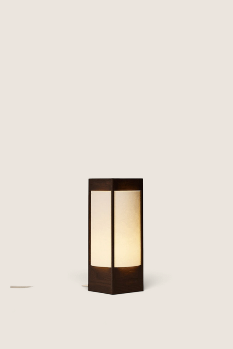 Bolina Andon table lamp in dark brown ash wood with a minimalist, sculptural design and soft, warm light diffusion.