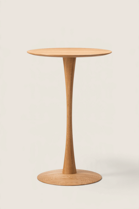 Bolina Trisse bar table in oiled oak with a round top and sculptural pedestal base, designed by Nanna Ditzel.