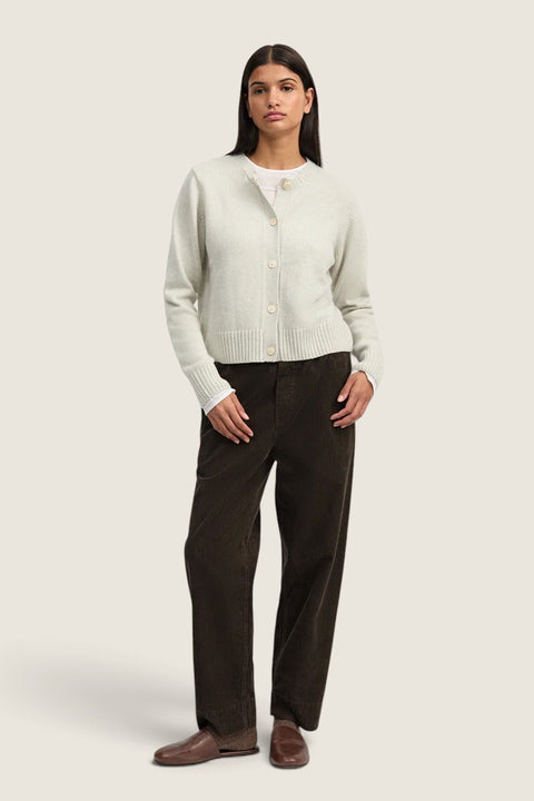 Model wearing Bolina Aiayu Coco corduroy pants in smokey brown with a light cardigan and brown leather loafers