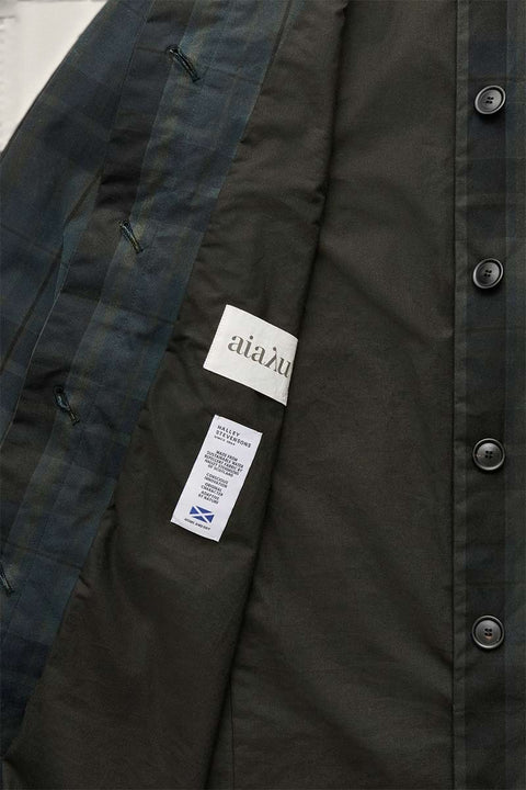 Bolina Aiayu Noor coat interior featuring dark plaid pattern, hidden button placket, and Halley Stevensons label.
