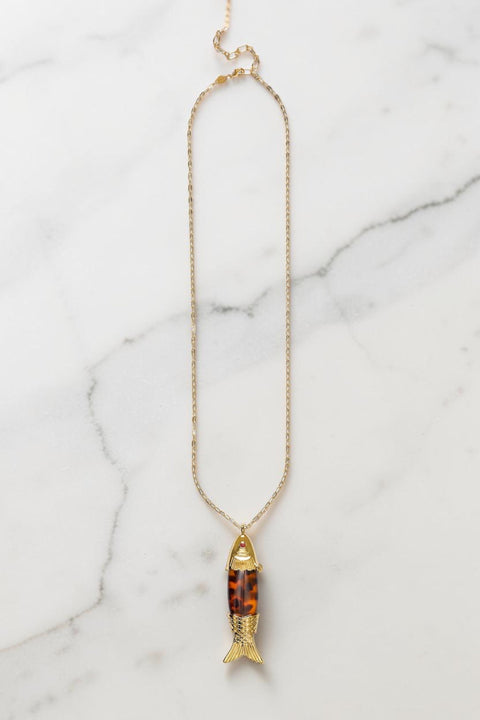 Bolina ANNI LU Big Catch gold necklace featuring a fish pendant with brown tortoiseshell pattern and gold details.