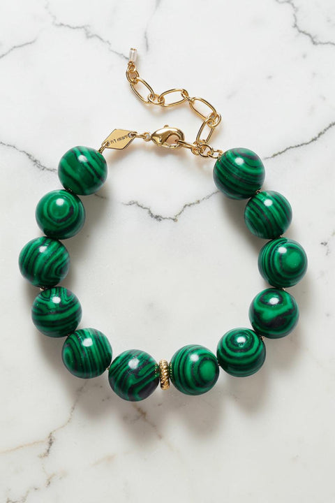 Bolina Anni Lu Malachite Dreams bracelet featuring large holly green malachite beads with gold-tone metal accents.