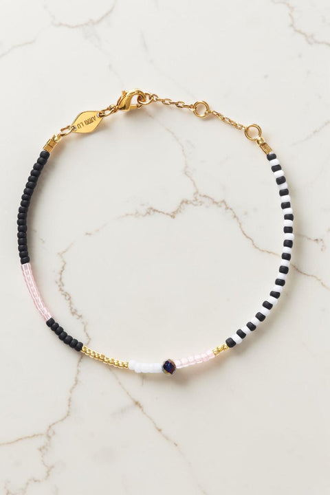 Bolina ANNI LU Mess Domino bracelet featuring black, white, and light pink glass beads with gold-tone metal accents.