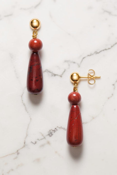 Bolina ANNI LU Hot Drops earrings featuring deep red jasper stones and gold-plated hardware on a marble surface