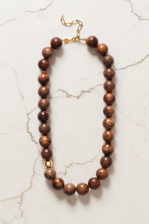 Bolina ANNI LU Woody Hot Chocolate necklace featuring large brown sandalwood beads and a single gold accent bead.