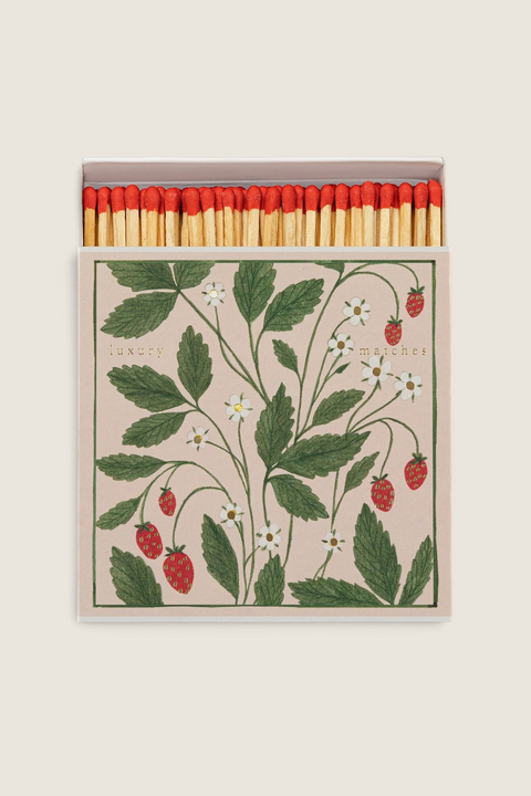 Bolina Archivist matchbox featuring a strawberry, leaf, and daisy illustration with gold foil accents and red tips.