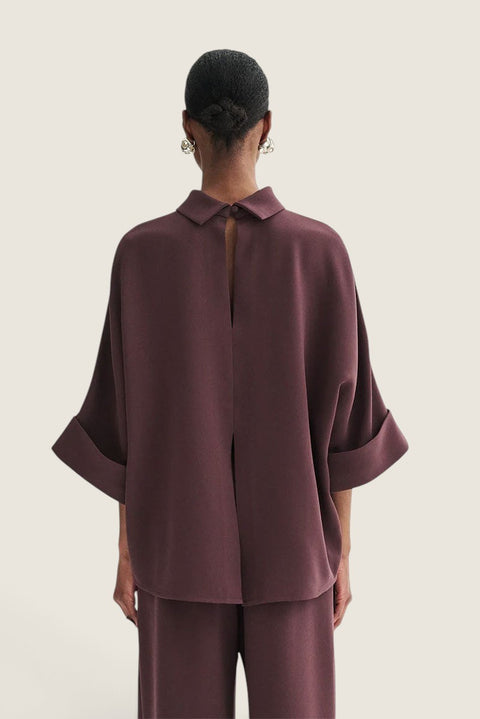 Bolina Bailee burgundy crepe georgette blouse with a loose fit and button closure worn on the back