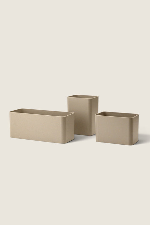 Bolina set of three beige biocomposite storage organizers for String System shelving in various rectangular sizes
