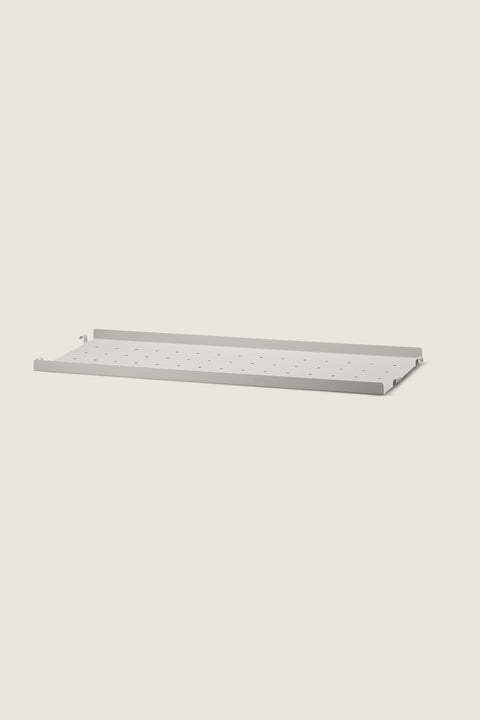 Bolina beige perforated metal shelf with low edges for String System, 58x20 cm size.