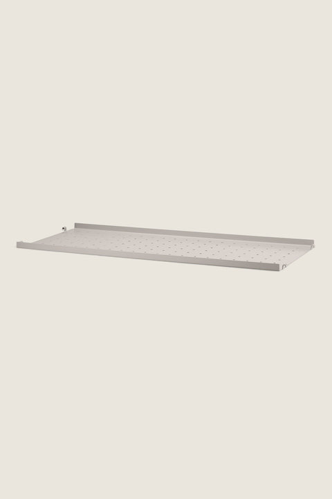 Bolina beige metal shelf with low edges and perforated surface for String System shelving units