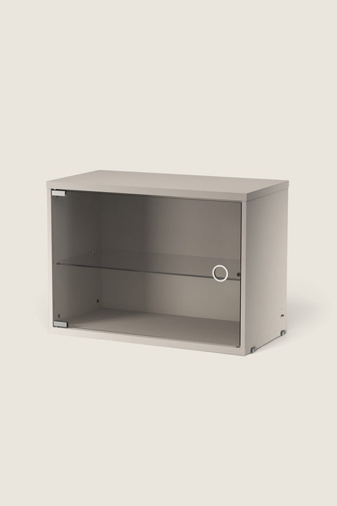 Bolina beige String display cabinet with a hinged glass door and internal glass shelf for modular shelving systems.