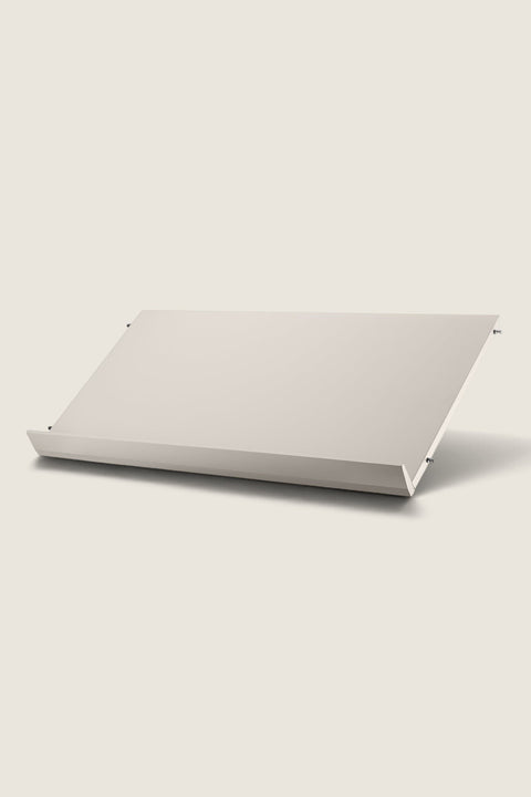 Bolina beige String System magazine shelf for displaying books and magazines, made of lacquered MDF.