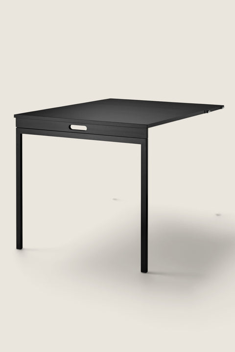 Bolina black ash folding table for String System, a space-saving wall-mounted desk in a minimalist design.