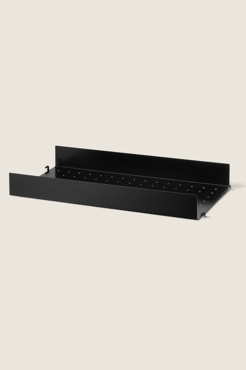 Bolina black powder-coated steel shelf with high edges and perforated base for String System shelving
