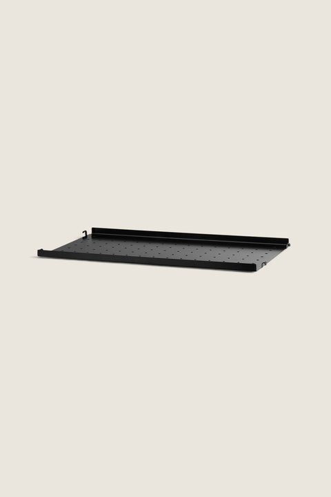 Bolina black powder-coated steel shelf with low edges and perforated surface for String System shelving units.