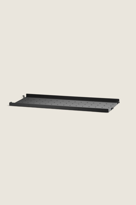 Bolina black powder-coated steel shelf with low edges and perforated surface for String System shelving units.