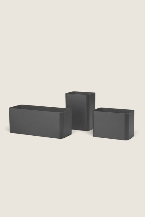 Bolina set of three black String System organizers made from biocomposite material for office or kitchen storage.