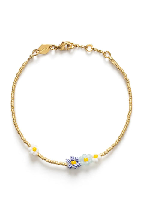 Bolina Anni Lu Bluebell Bloom bracelet with glass beads, aquamarine, porcelain, and gold details. Features flower charms and a lobster clasp.