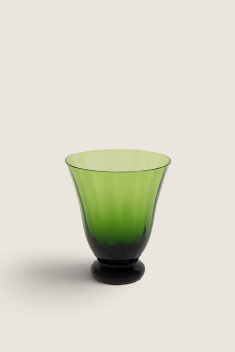 Bolina Boule green glass tumbler with a soft rounded shape and elegant pedestal base for colorful table settings.
