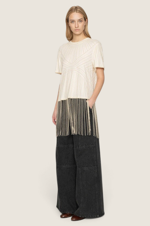 Bolina Carlotta cream cotton top featuring hand-beaded graphic patterns and long fringe hem worn by a model
