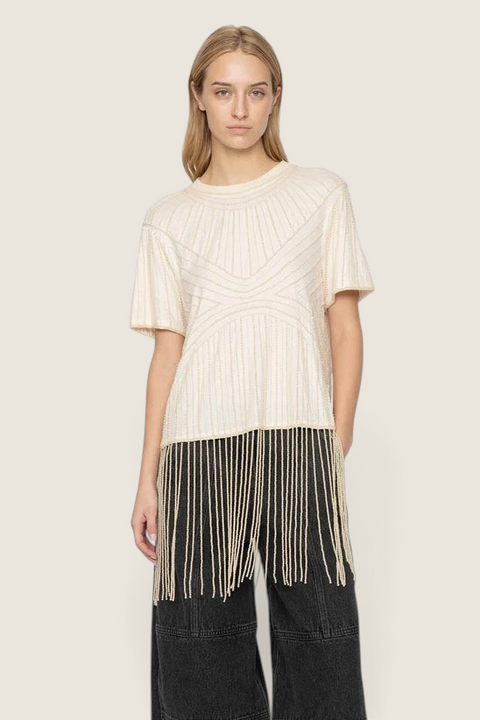 Bolina Carlotta cream cotton top with hand-beaded graphic patterns and long beaded fringe hem worn by a model