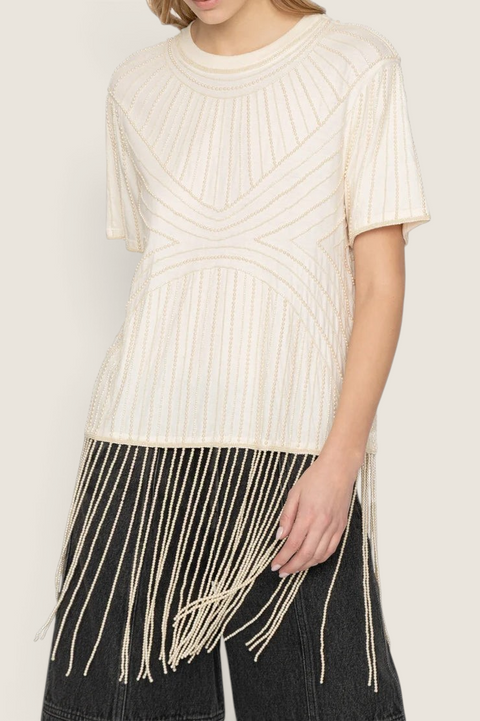 Bolina cream cotton Carlotta top featuring hand-beaded graphic patterns and long beaded fringe hem on a model