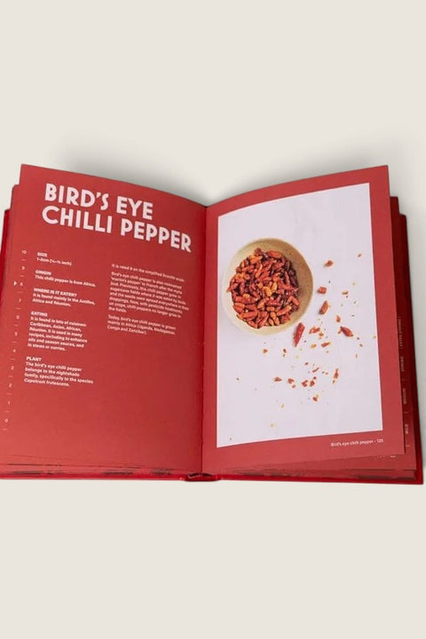Bolina Chillies cookbook open to the Bird's Eye Chilli Pepper page with red background and detailed spice facts.