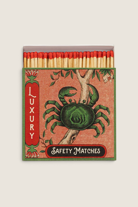 Bolina luxury safety matchbox featuring a green crab illustration on a branch with red-tipped matches inside