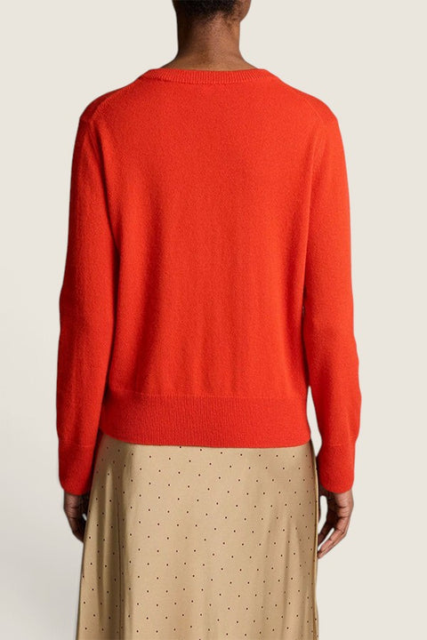 Bolina crimson red fine-knit cashmere sweater with ribbed hem and cuffs worn by a model, back view