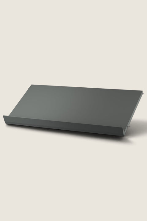 Bolina dark grey metal magazine shelf for String System, 78 cm wide, designed for displaying books and magazines.