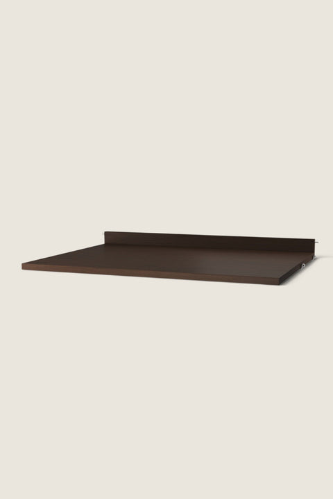 Bolina dark oak work desk shelf for String System with a low back edge for stability and a sleek wooden finish.