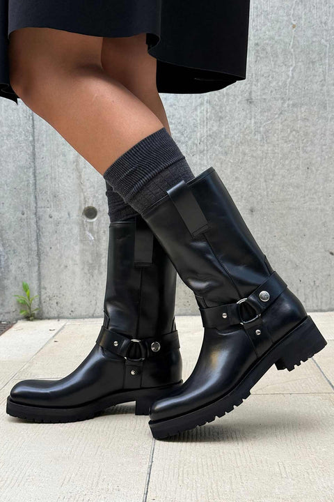 Bolina Isabel boots in shiny black leather with silver ring hardware and a chunky rubber sole, mid-calf height.