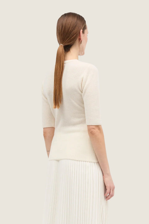 Bolina Kami ivory short-sleeved cashmere knit top with a round neck, worn by a model, back view.
