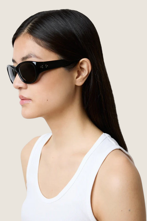 Bolina LIÉ STUDIO The Lee black oversized round sunglasses with wide temples worn by a woman in profile view