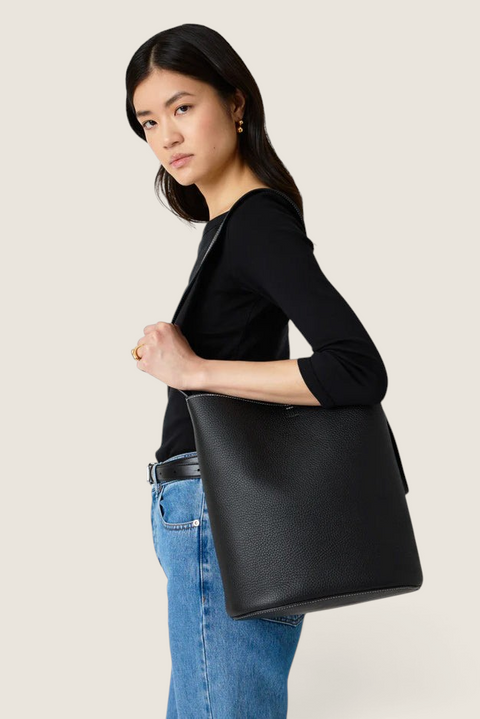 Bolina LIÉ STUDIO Norma Tote in black textured leather worn over the shoulder by a model.