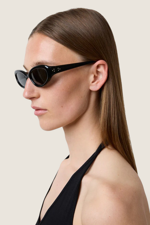 Bolina LIÉ STUDIO The Robyn black cat-eye sunglasses with rounded acetate frames worn by a model in profile view.