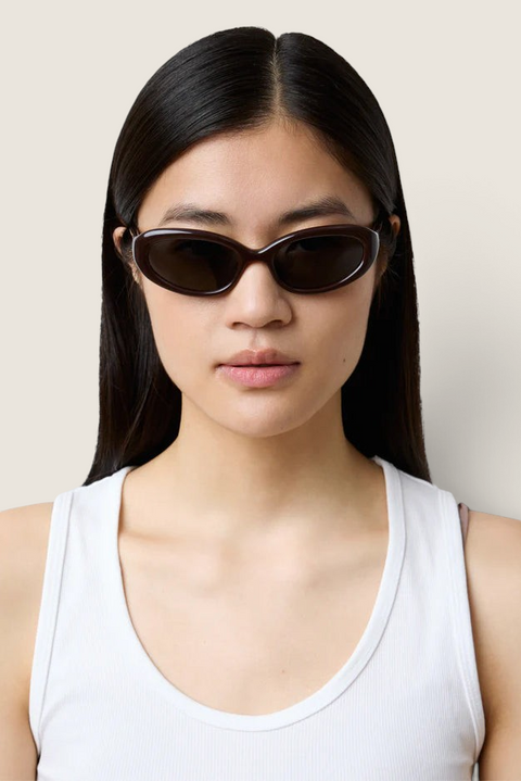 Model wearing Bolina LIÉ STUDIO Robyn dark burgundy cat-eye sunglasses with a rounded frame
