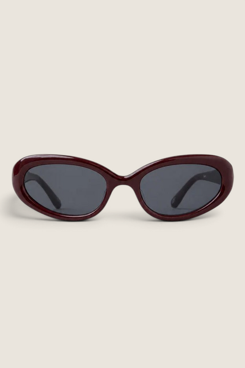 Bolina LIÉ STUDIO Robyn cat-eye sunglasses in dark burgundy with rounded frames and dark grey lenses.